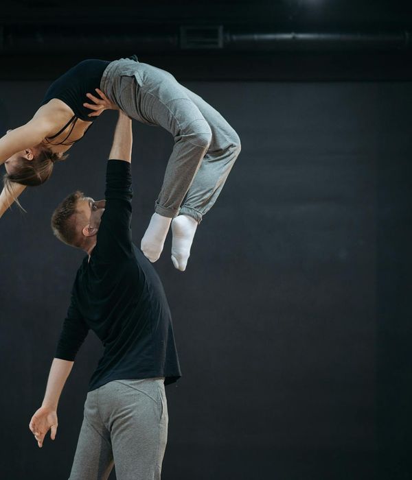 Man performing balanced physical movements in a modern room